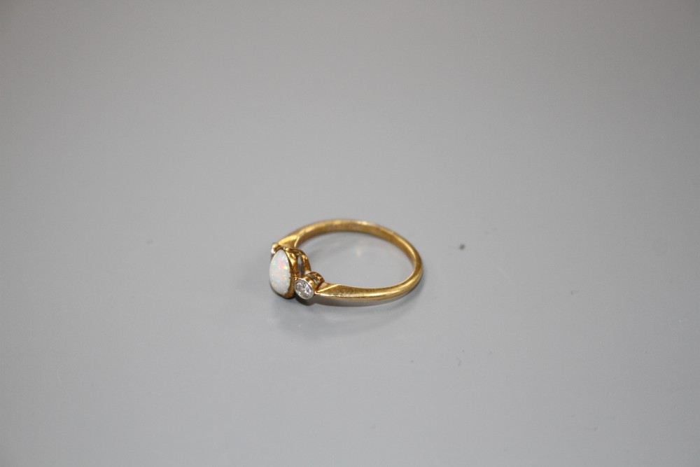 A mid 20th century 18ct and Pt, white opal and diamond three stone ring, size O/P, gross weight 2.8 grams.